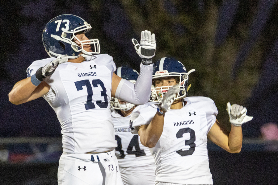 Senior Ty Stone, junior Doug Lantz and senior Mason Birch get airborne after Lantz scored a touchdown against Hays.