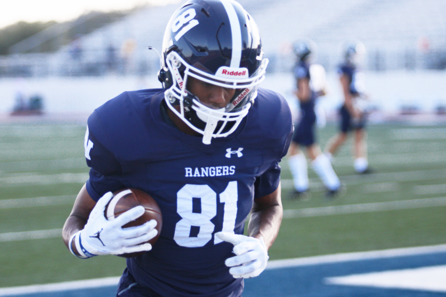 Senior wide receive TJ Hunt warms up before the Canyon game at home.