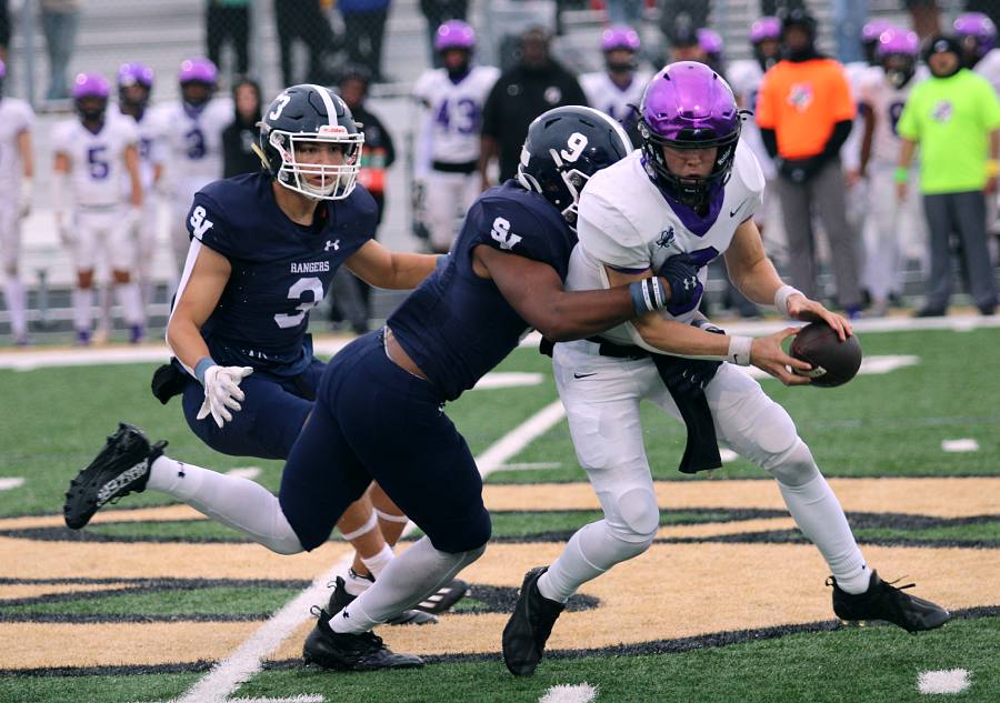 During playoff action Nov. 25, senior defensive end McLain Garrett pulls down the Fulshear quarterback, with assistance from junior defensive end Doug Lantz in the 31-13 win.