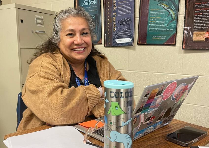 Virginia Pittman smiles while helping one of her students during a fifth period class on Dec. 9.