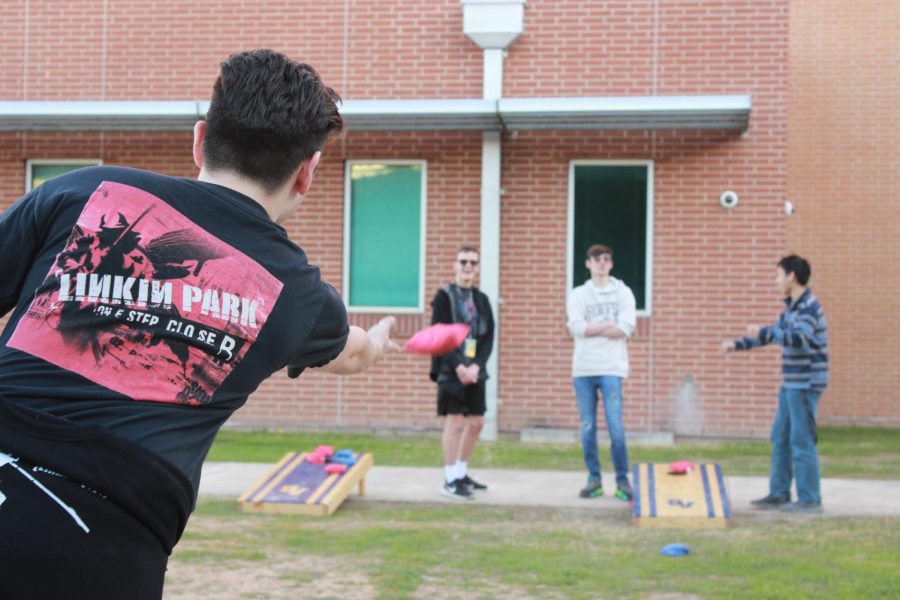 The Cornhole Club practicing in the back of the school on Jan. 10.
