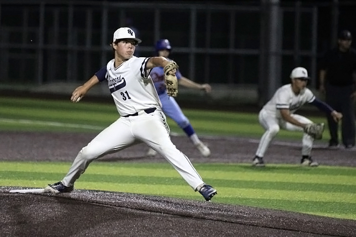 Junior MJ Espinoza pitches  at the baseball playoff game in 2022.