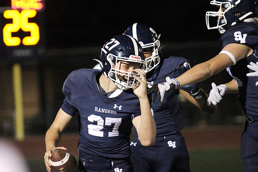 Junior Nick Dudzikowski turns to celebrate with his teammates after intercepting a pass against Seguin and returning it for a touchdown.