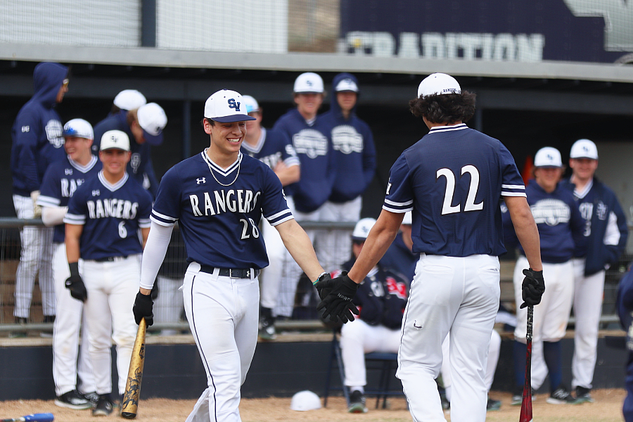 While they compete in the 2023 home run derby, seniors Ethan Gonzalez and David De Hoyos slap hands. De Hoyos won the homerun derby.