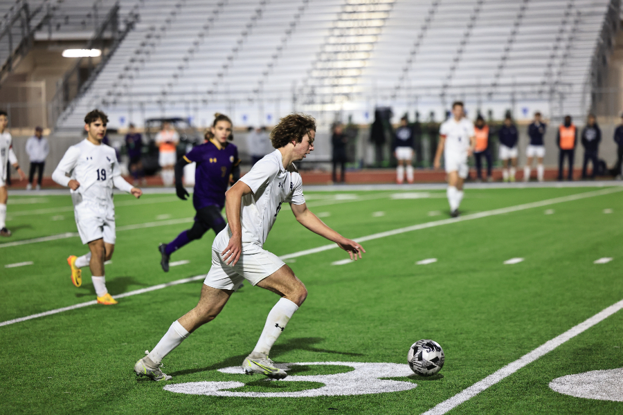 Junior Greg Gelsone dribbles down the field in the Rangers' first match against Pieper. The boys beat Pieper out for the second playoff seed. 