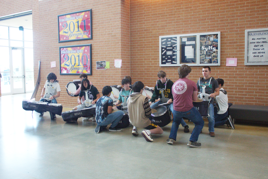 Band plays their instruments during state send off. 