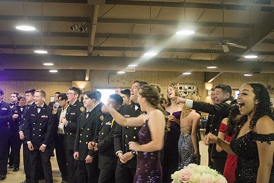 NJROTC cadets gather around to watch a slideshow at Knibbe Ranch put together by fellow cadets for the Military Ball on Sat. 22.  
