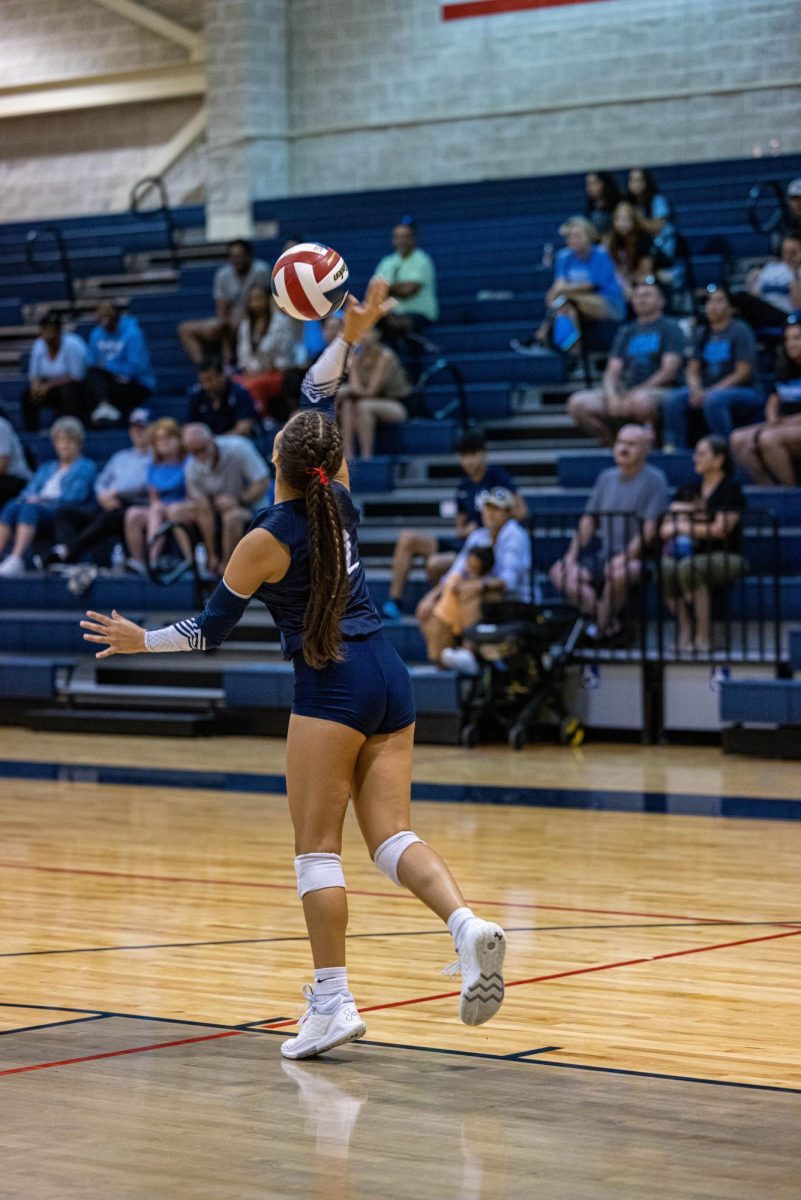 Sophomore, Sophia Fuentes, serves the ball against Harlan.
