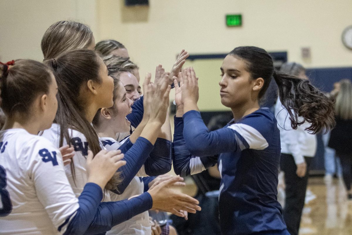 Senior defensive specialist Brittan Fedyk celebrates with her teammates over their Steele victory Sept. 1.