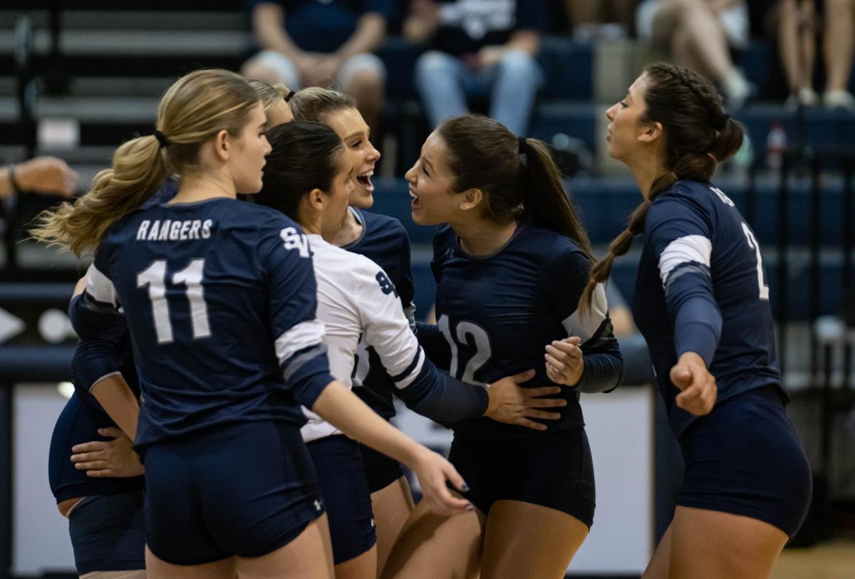 Volleyball celebrates as they score against the 6-2(district) Pieper team. 
