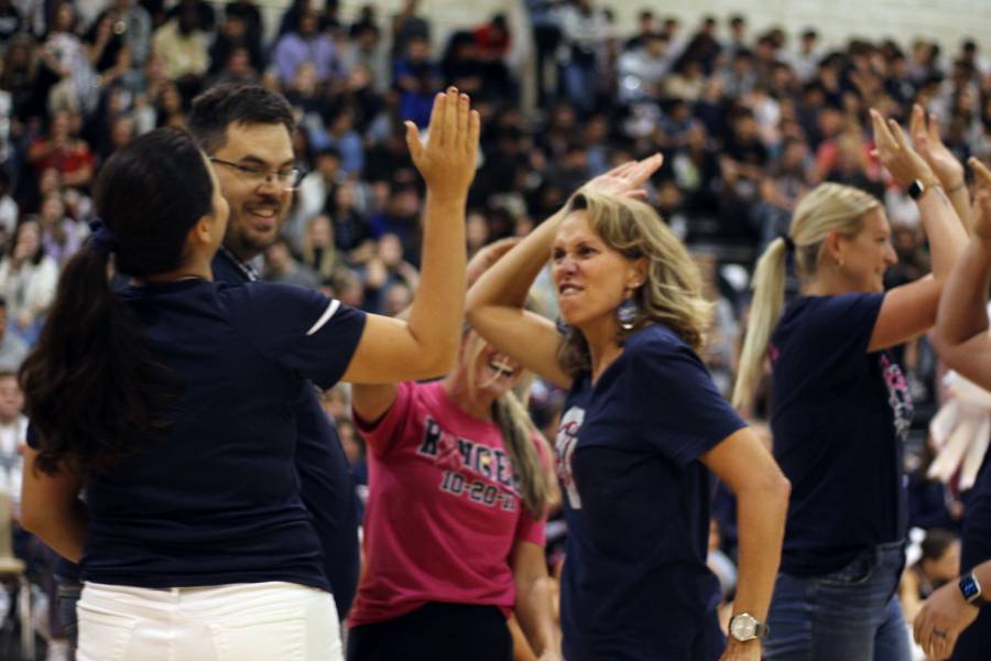 Spanish teacher Laura Heldmann celebrates the teacher's tug of war win over the junior class.