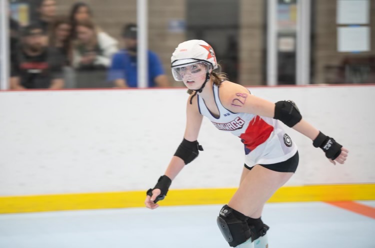 Sophomore Maddie Cuff skating on the rink, representing her team the Conroe Scallywags.