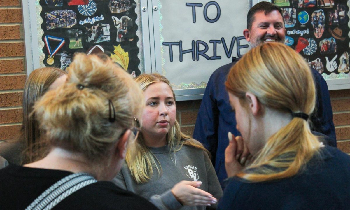 Junior Tatum Williams talks to eighth grade students and parents about the student athletic trainer program.