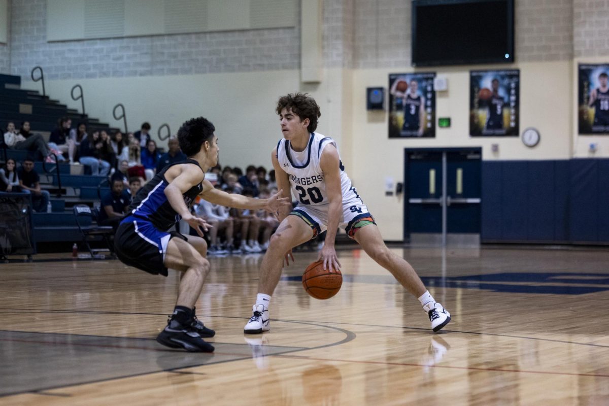 Senior Gavin Londrie goes between his legs against his San Marcos opponent.