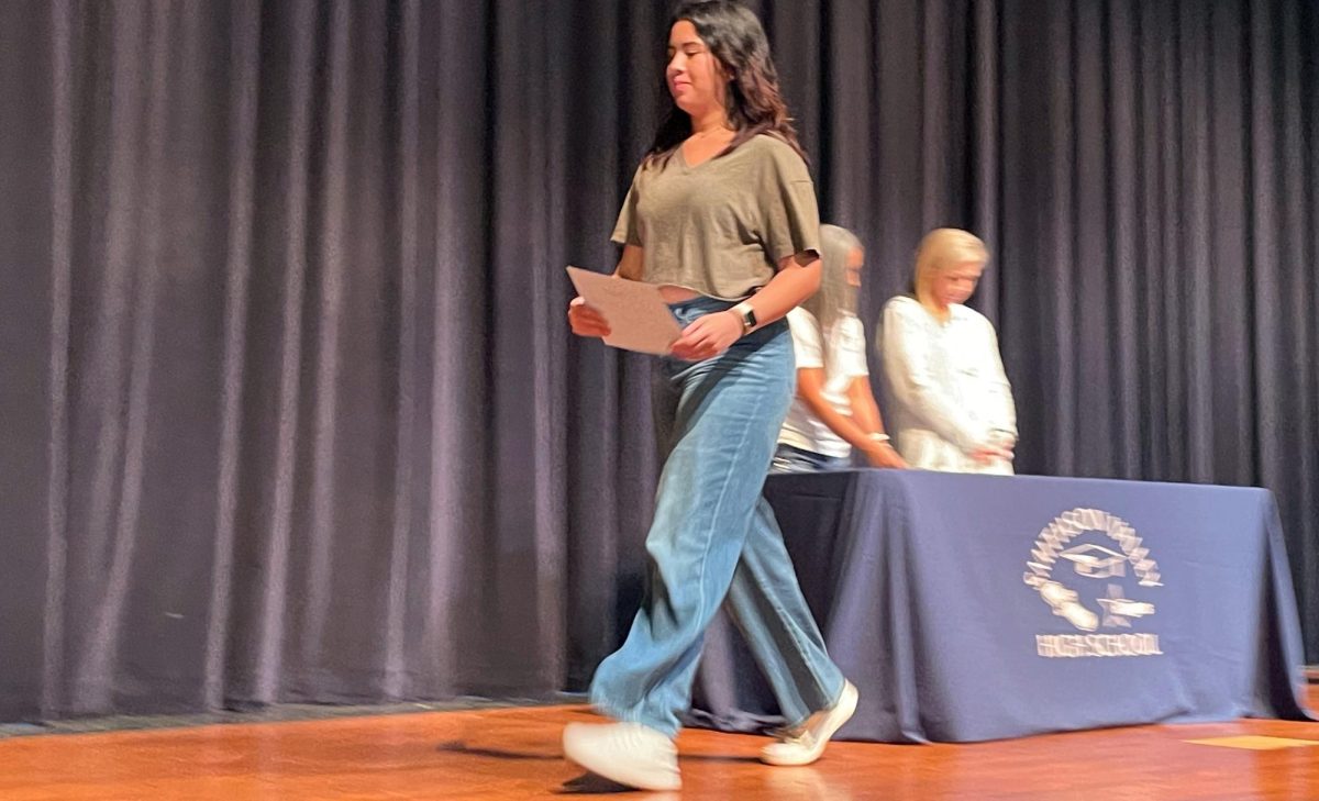 Once handed her award senior Lauren Sotelo walks off stage to join the other students 