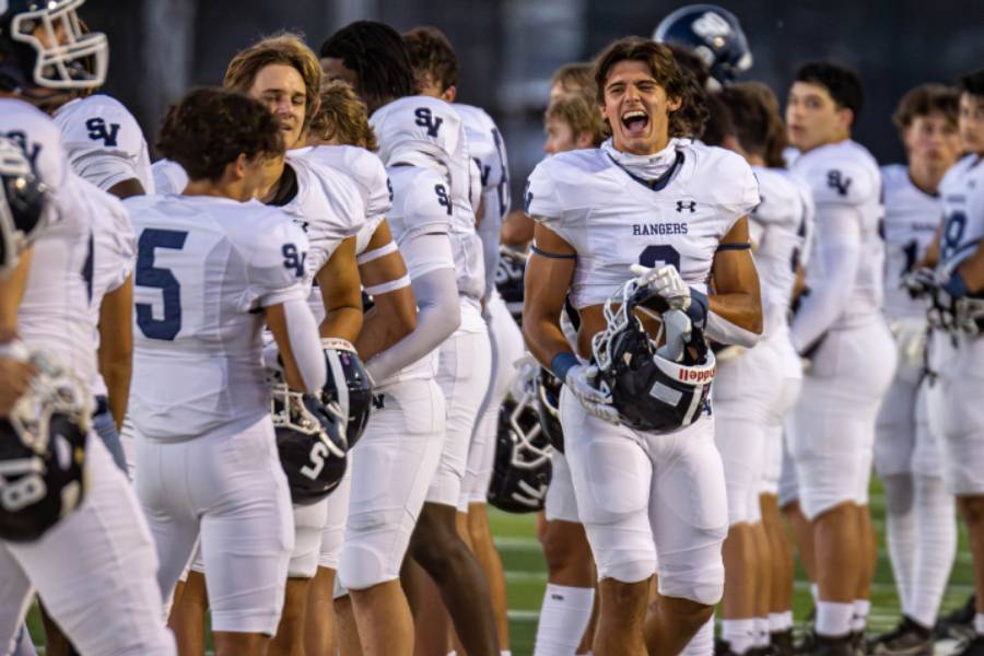 Texas State baseball commit Zach Gingrich screams on the sideline with joy during the Boerne Champion game.