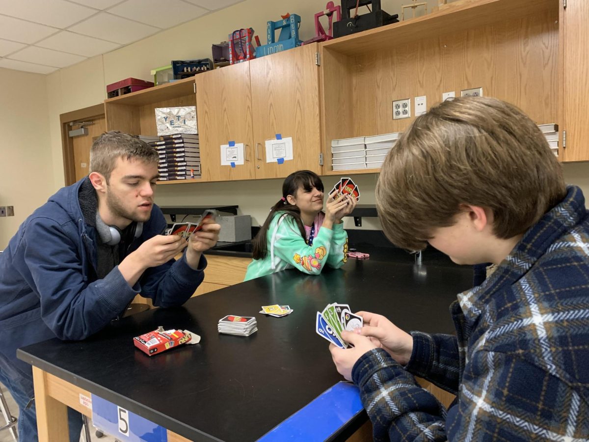 Senior Greyson Clark and Freshman Roman Parkas playing UNO with another club member