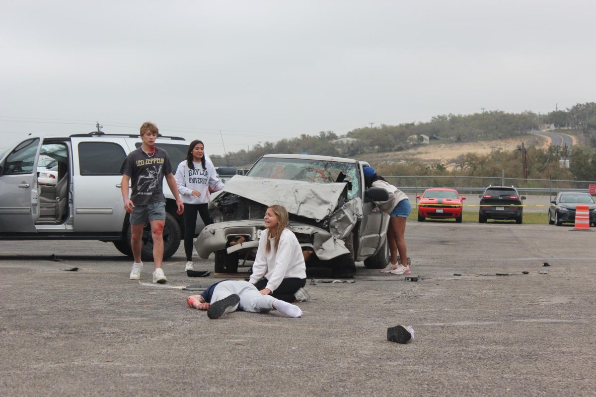Seniors Ashlyn Mansfield and Victoria Williams talk to Senior Zach Gingrich in the car during the shattered dreams presentation on March 7.