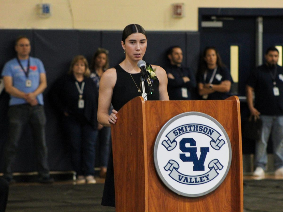 Senior Ella Pickron introduces a speaker during the Shattered Dreams memorial service March 8. Guest speaker Curtis Herring spoke about his experience with loss because of reckless driving.