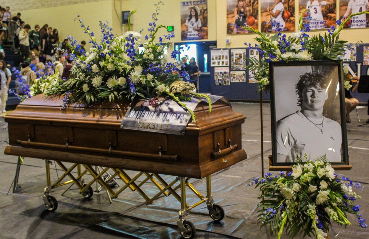 At the end of the mock funeral on March 8, seniors Karlie Jackson, Kannon Day, Ashlyn Mansfield, Victoria Williams and Ryder Bonser placed a banner and a baseball glove on the casket for senior Maverick Minister. The funeral aimed to teach students about life after a loved one dies from drunk driving.