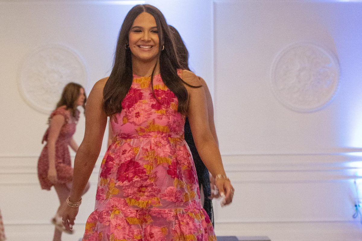 Starting her way up the runway, senior Abbey Alcoser looks upon the crowd