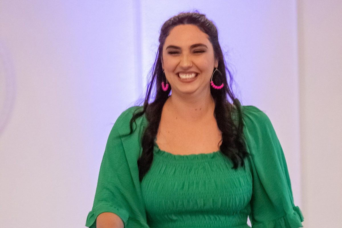 Making her way down the runway, culinary teacher Meagan Masterson is seen smiling 