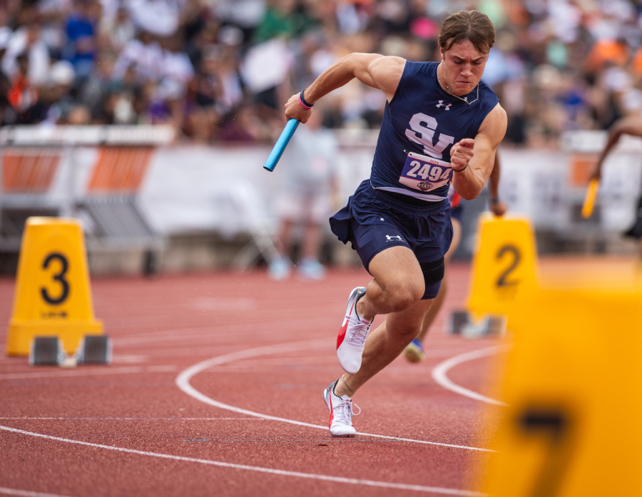 Brad Sowersby, the block starter for the 5A 100m 4x10 relay, held May 3, makes his way around the curve to hand off the baton. 
