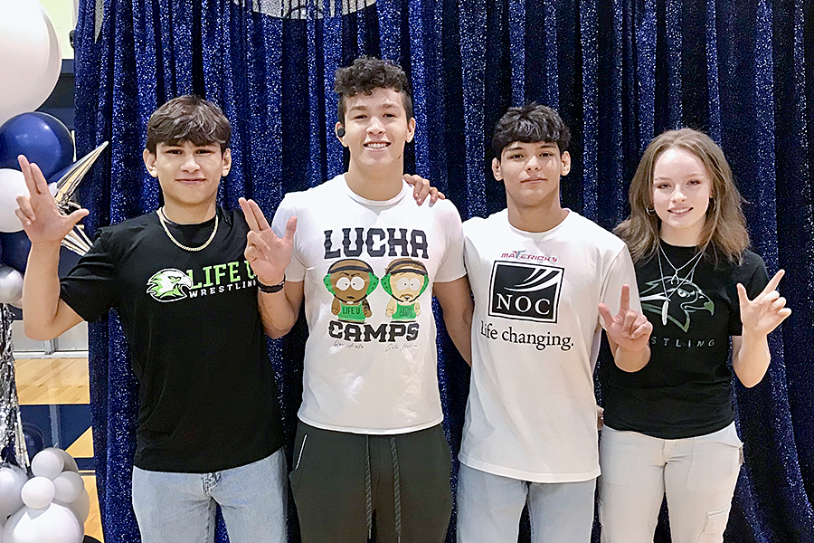 Senior wrestlers Tristan Luna, Efren Arizmendez, Absalon Valencia and Sierra Rieschick pose at the signing May 15. Luna, Valencia and Rieschick signed that morning, and Luna signed to wrestle at Life University earlier this semester.