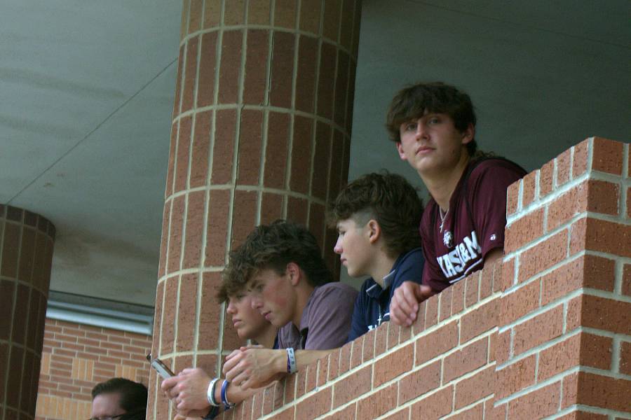Junior Travis Collins waits at the top of the stairs after racing his boat. All students had to wait and watch the other groups when they were done.
