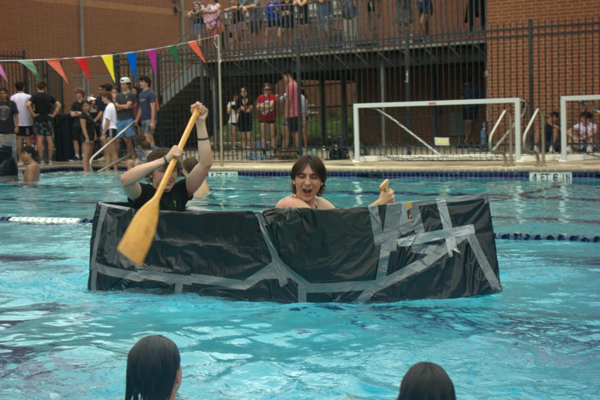 Junior Alec Suarez talks back to the student lifeguards after they were teasing him. Suarez built a two person boat with his partner junior Anderson Thomas.