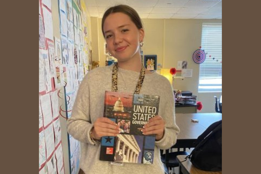 Junior Wiebke Isermann poses with her U.S. government textbook. Isermann is a foreign exchange student from Germany.