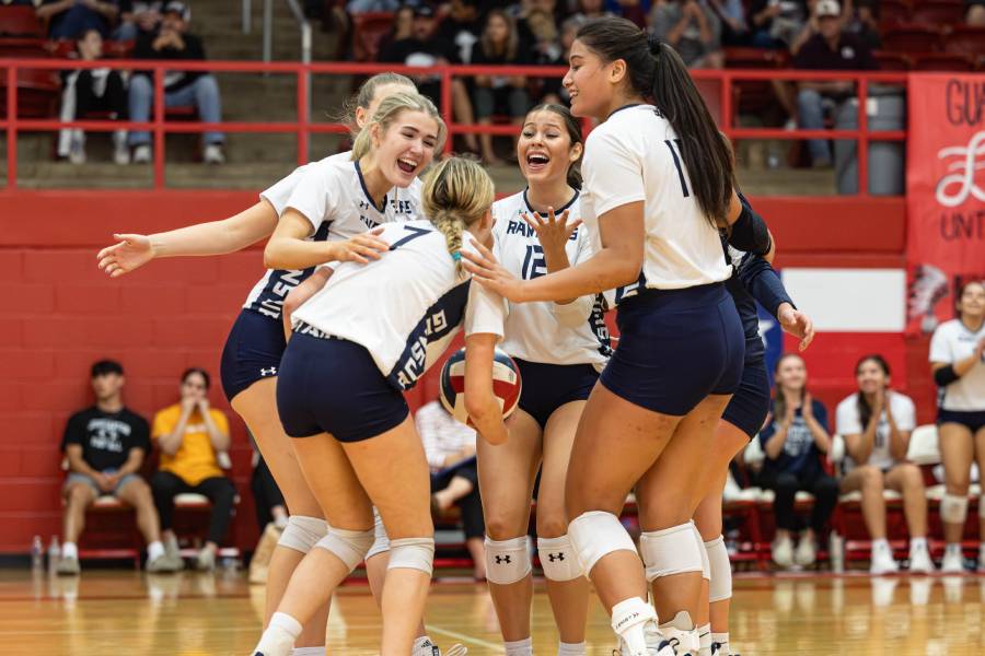 Senior Ava Annunzio (left), junior Sophia Fuentes (middle), and others celebrate freshman Clair Bolton (No. 7) on her kill.