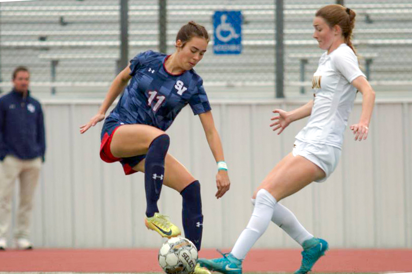On Jan. 3, sophomore Izzy Sutherland dribbles the ball around her opponent. They won against Brennan 4-0.