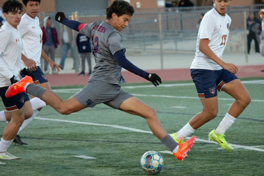 Senior Joshua Mazzotta attempts to kick a goal agains his opponent from Maddison on Jan. 11.