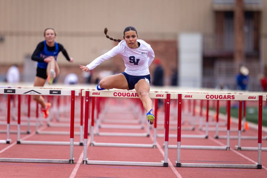 Sophomore Briseida East leaps over the hurdle to cross the finish line. East competed in the 100m and 300m hurdles placing top 3 in each event.