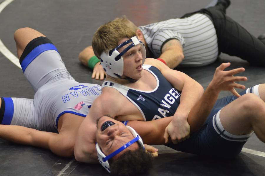 Freshman Joseph Warrick pins his opponent while making it look easy. Warrick is one of many who have qualified for regionals.