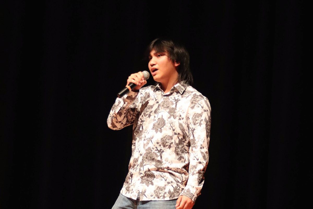 Junior Milo Corona performs "Yesterday" by The Beatles at the talent show Feb. 27. Corona is also a member of student council and helped organize the show.