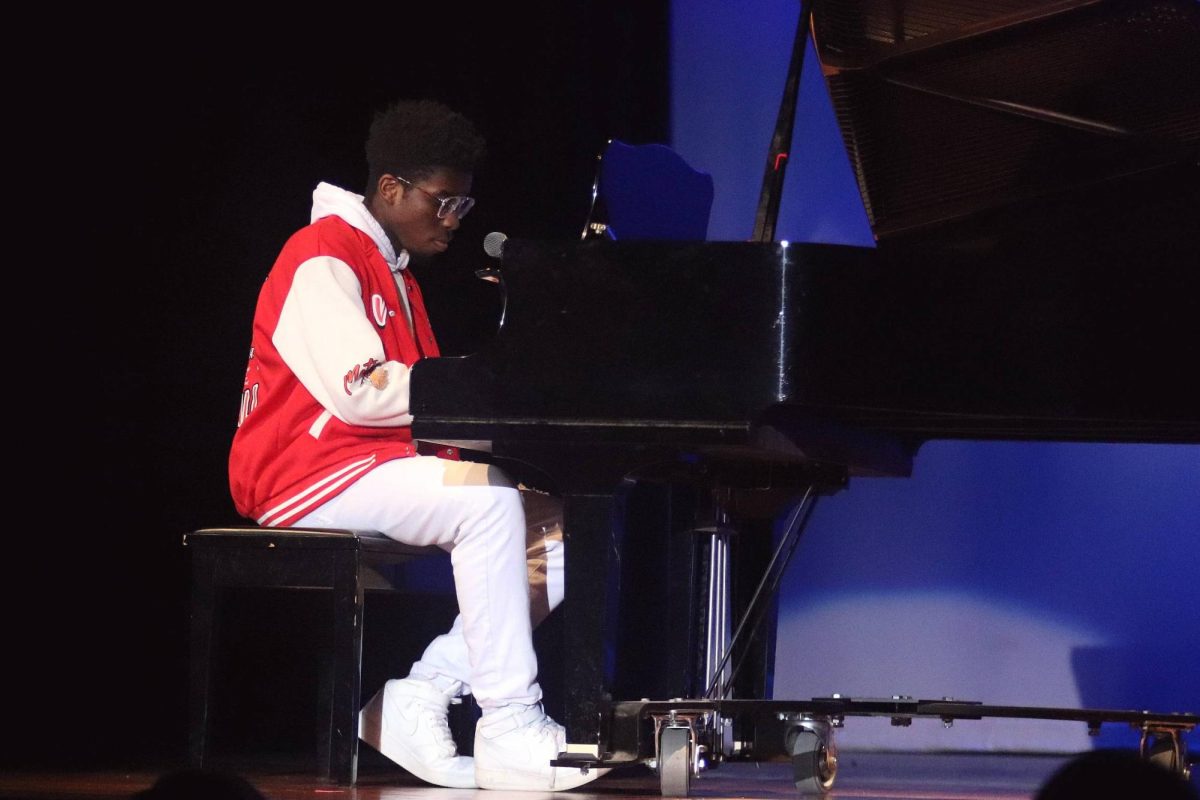Senior Lemuel Forlu plays the piano and sings at the talent show Feb. 27. Forlu wrote and composed his piece himself.