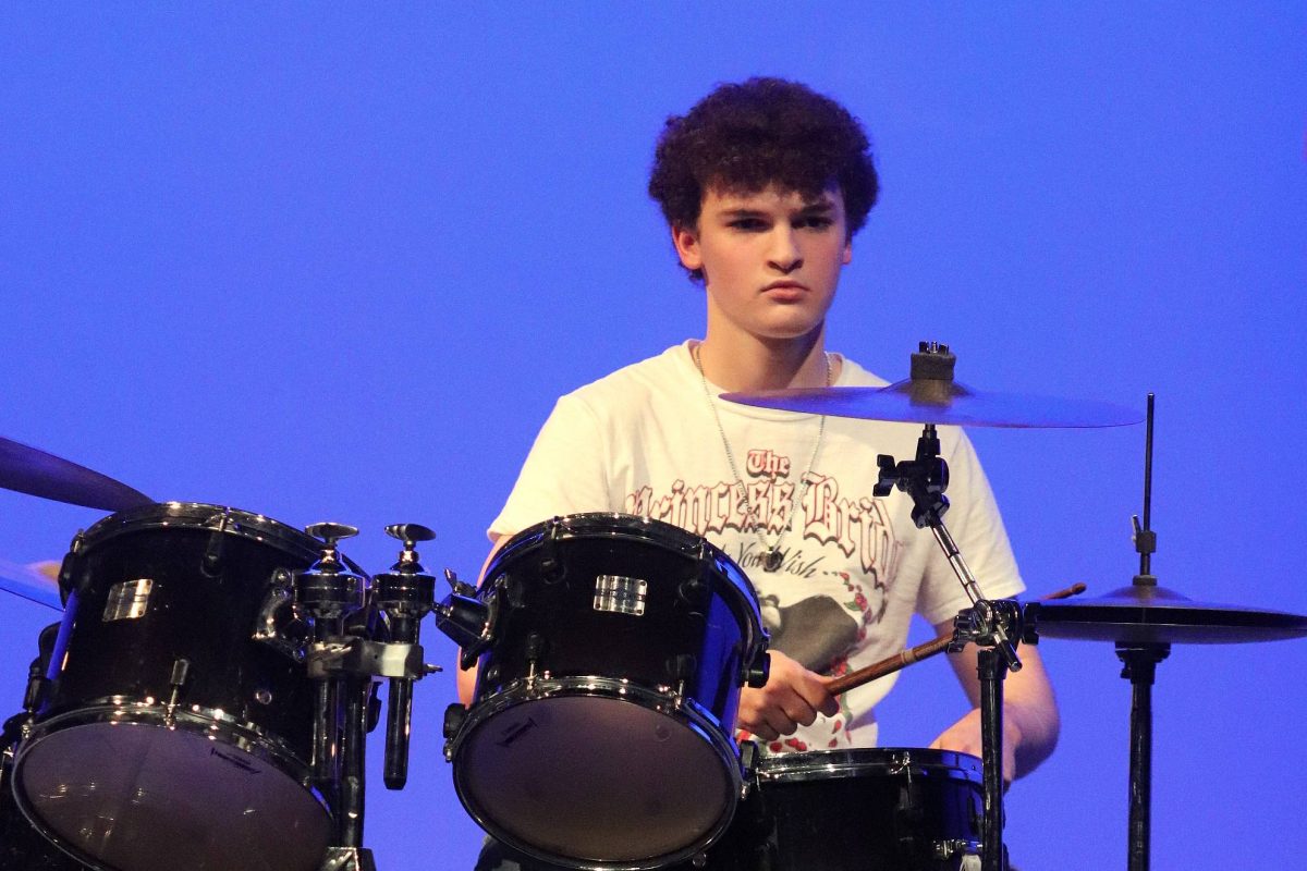 Junior Thomas Morgan plays the drumset with his band.